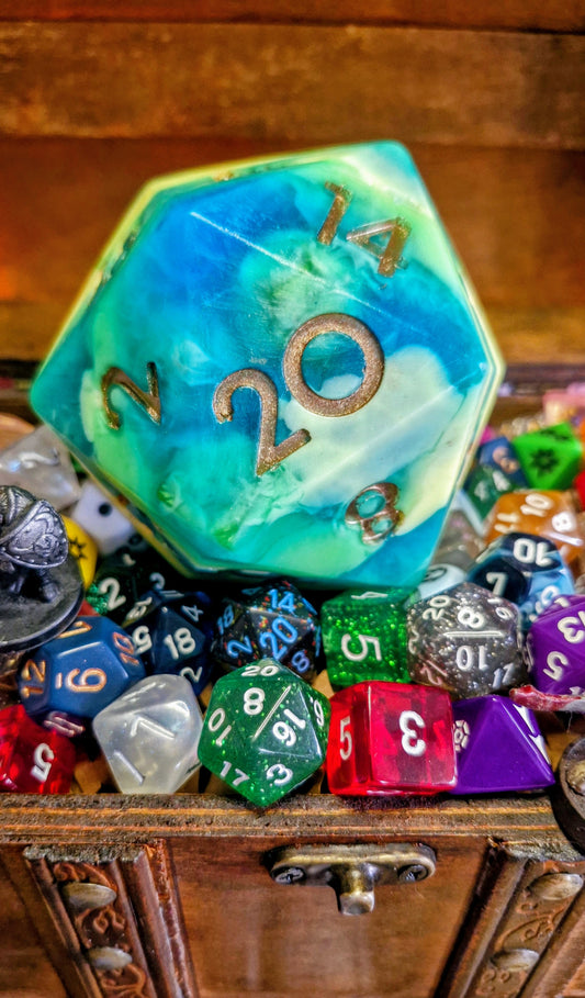 Handmade D20 soap dice in Outrider Games yellow and blue colours, scented with sea salt and sage, displayed on wood with a natural fantasy theme – exclusive collaboration between The Druid’s Grove and Outrider Games Lichfield close up