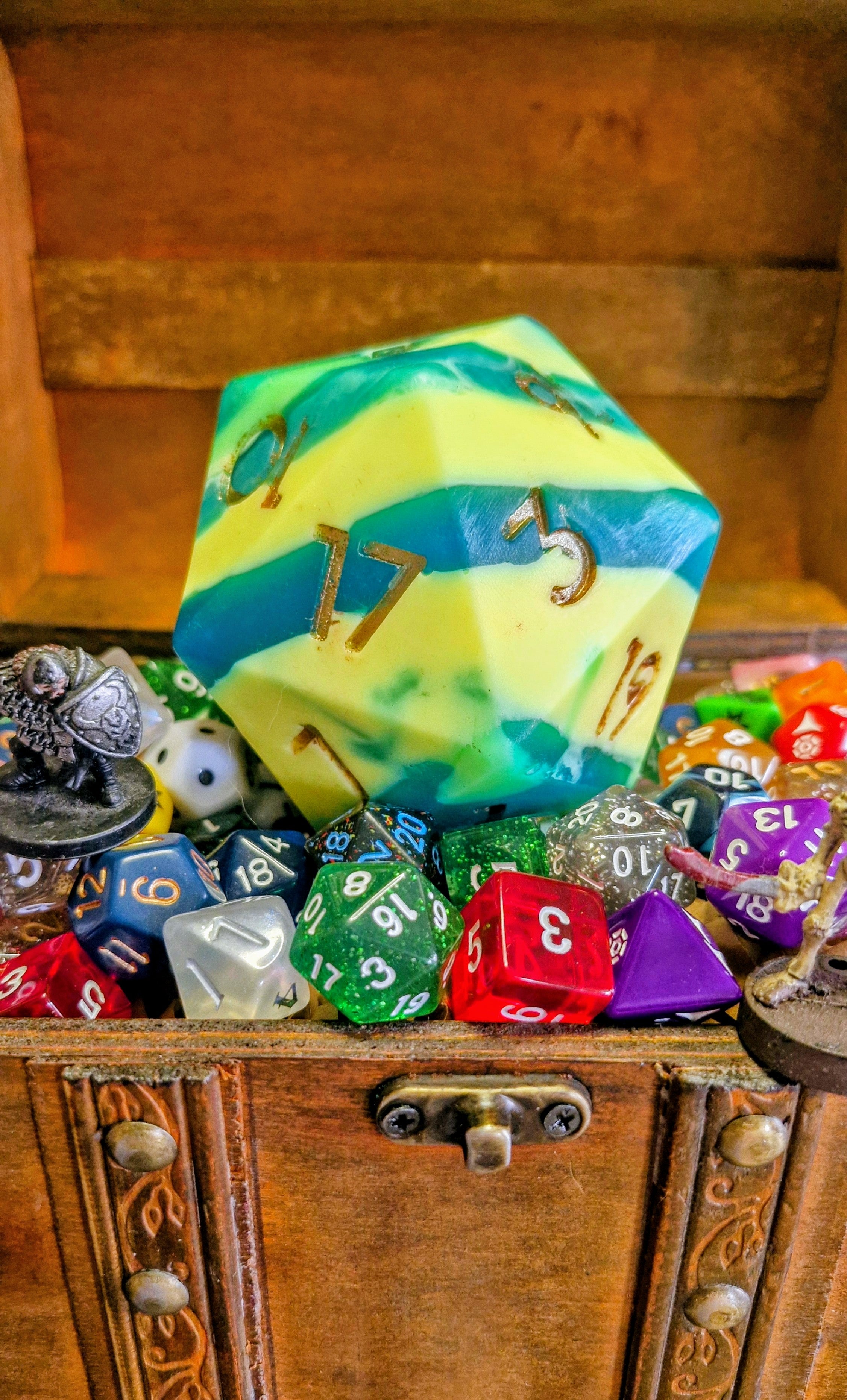 Handmade D20 soap dice in Outrider Games yellow and blue colours, scented with sea salt and sage, displayed on wood with a natural fantasy theme – exclusive collaboration between The Druid’s Grove and Outrider Games Lichfield